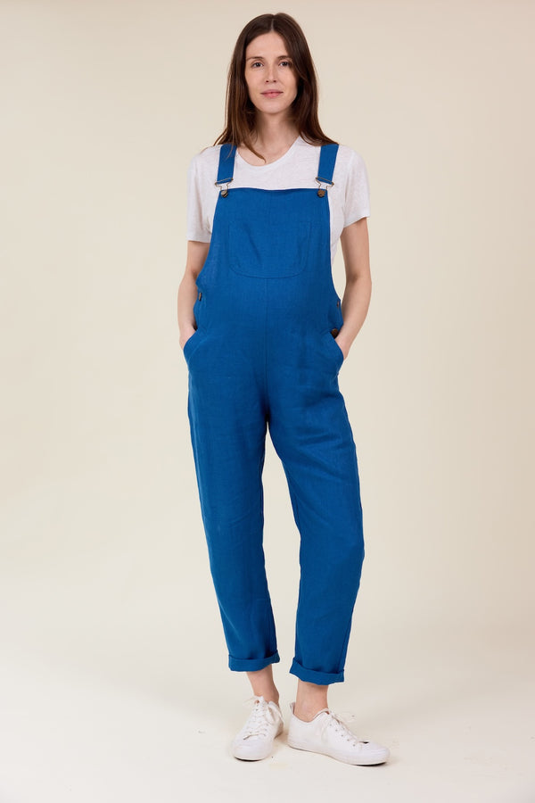 A person wearing blue linen dungarees